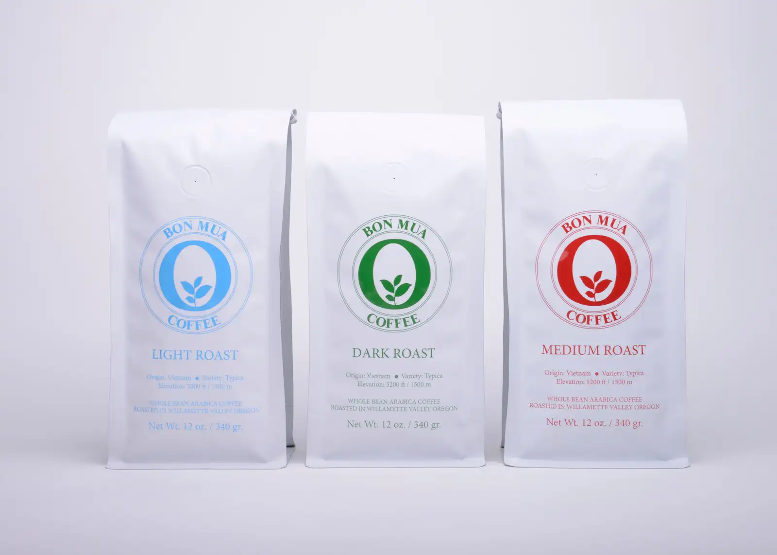 Three Bon Mua coffee bags standing together — light, medium and dark roast.